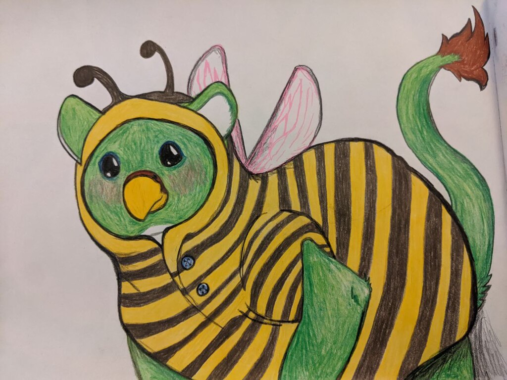 A green gryphon with a white belly and brown paws blushes lightly as they wear a bee costume. Artwork by Fanfalla. Colored pencil on white paper.